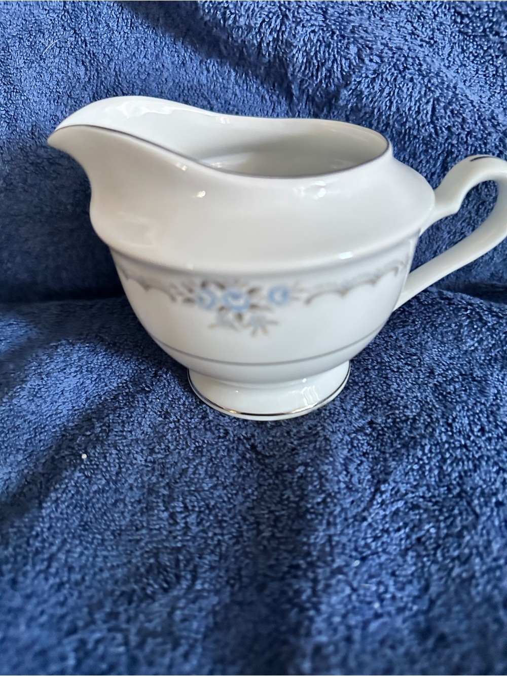 Elegant White Porcelain Creamer with Blue Floral Accent